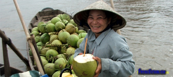 Selling coconuts at a floating market on the Mekong River Selling coconuts at a floating market on the Mekong River